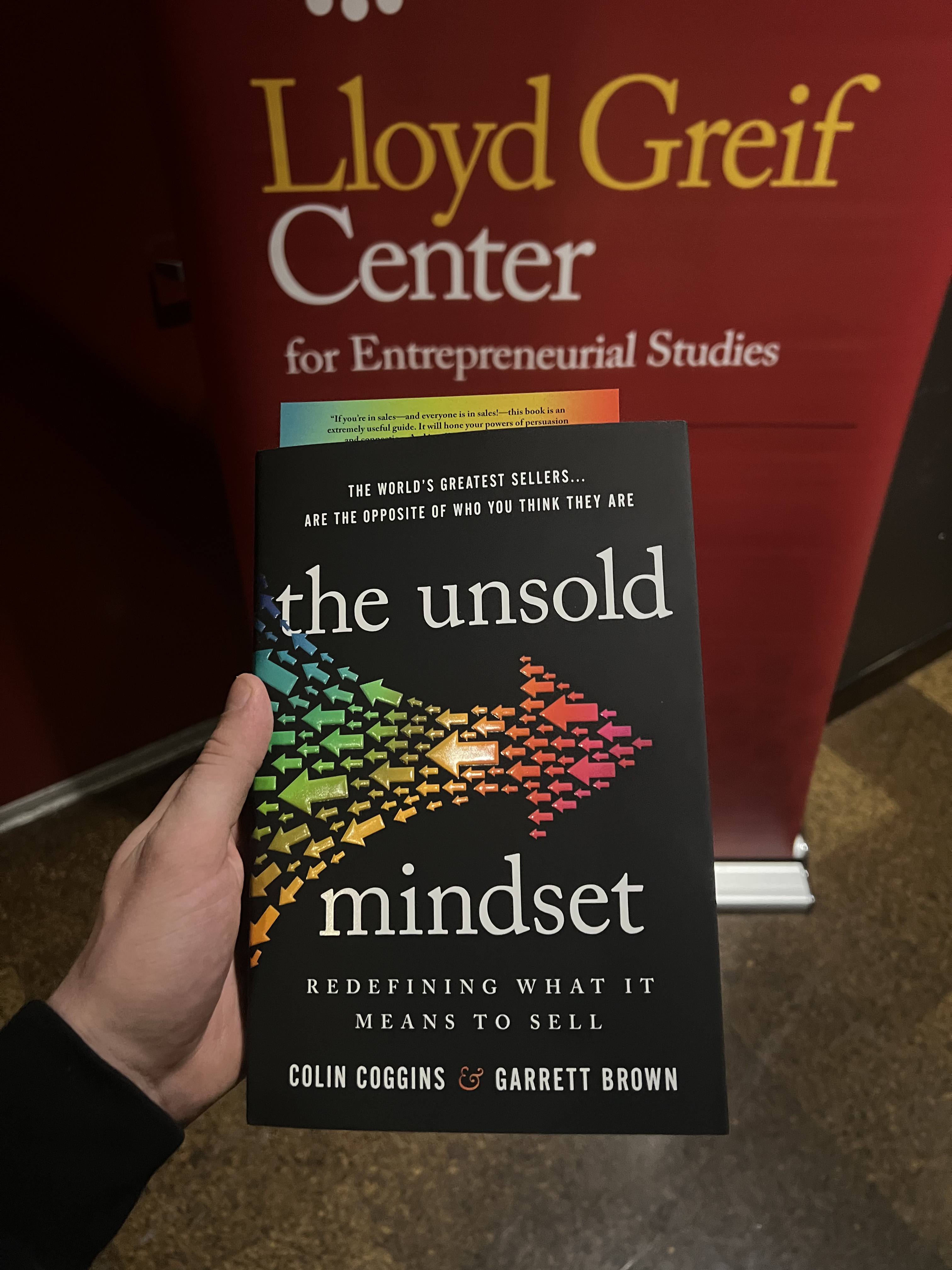 The Unsold Mindset by Colin Coggins and Garrett Brown, held in front of the USC Marshall Lloyd Greif Center sign